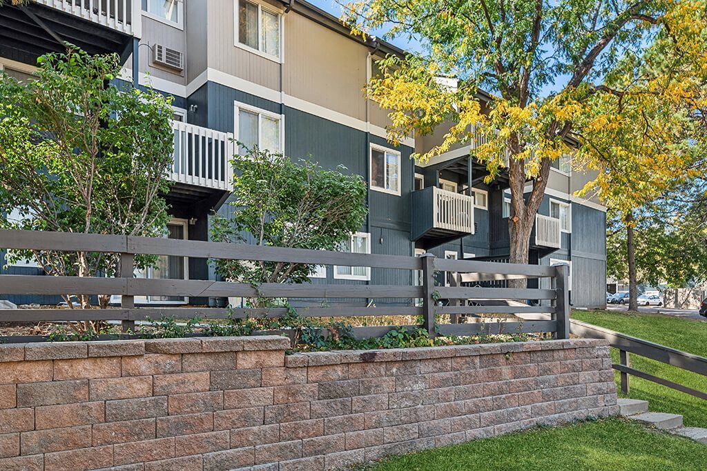 Exterior Buildings with Fence at The Pines in Lakewood CO